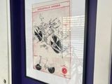 a picture of a bathroom with a toilet and a picture on the wall
