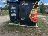 a black box with a pizza on it sitting in the middle of the road