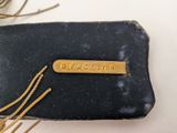 an image of a black purse with a gold bar on it