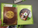 a person holding a green case with a dvd inside of it