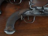 two guns that are on a table together
