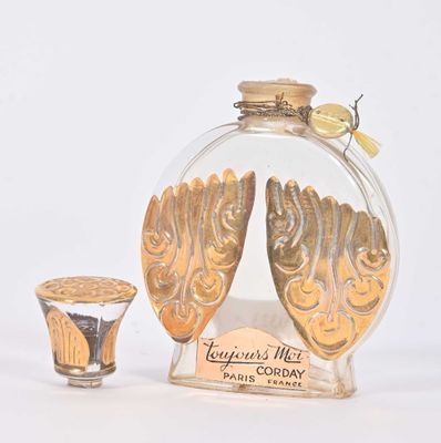 a small glass bottle with a gold decoration on it