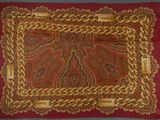 an image of a red and gold scarf with gold chains on it