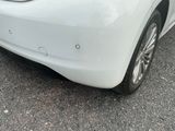 a white car that is parked on the side of the road
