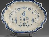 a blue and white platter with a design of birds and flowers