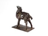 bronze statue of a goat on a marble base on a white background