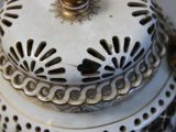 a close up of a white and gold vase with a lid