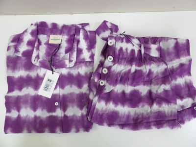 purple and white tie dye shirt and pants on a white surface