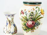 two vases sitting next to each other on a white surface