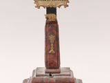 statue of a crucifix on a pedestal with a cross on it