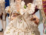 a figurine of a man and a woman in a carriage