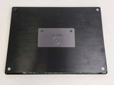 the back panel of a laptop with a metal plate on top of it