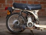 a motorcycle that is parked in front of a brick wall