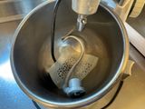 a metal bowl with a metal strainer inside of it