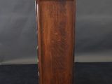 an old wooden cabinet with two drawers on top of it