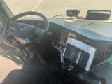 a picture of a car dashboard with a cell phone in the driver ' s seat