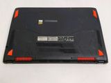 a black laptop with red trims sitting on a white surface