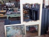 two framed pictures on the floor in a room