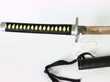 a black and gold samurai sword with a black handle