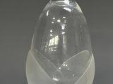a clear glass vase with a curved design on it