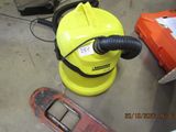 a yellow blow dryer sitting on the floor next to other items