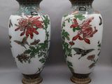 pair of chinese vases with birds and flowers painted on them