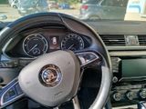 a steering wheel and dashboard of a car in a parking lot