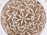 a brown and white plate with a design on it
