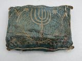 a close up of a small piece of cloth with a menorah on it