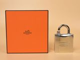 an orange box with a silver padlock next to it on a beige surface