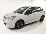 the small white car is parked in a white room