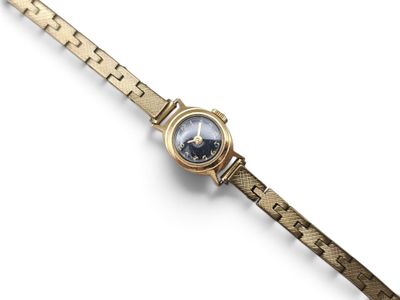 a close up of a wrist watch on a white surface