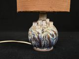 a lamp that is sitting on a table with a book on it