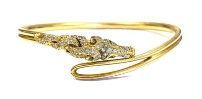 a close up of a gold bracelet with a snake on it