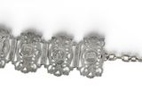 an image of a silver bracelet with a key on a chain