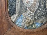 a mosaic of a woman holding a bird in her hand
