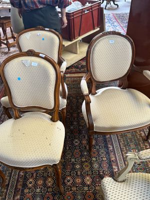 a man standing next to a group of chairs in a room