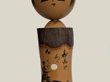 a wooden doll with a black and white design on it ' s head