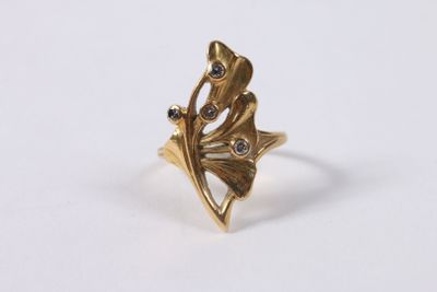 a close up of a gold ring on a white surface
