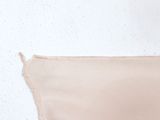 someone is peeling off a piece of fabric on a white surface