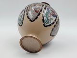 an image of a decorative vase on a white surface