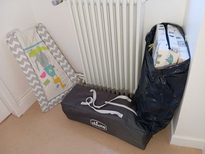 a black bag sitting next to a white radiator in a room