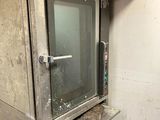 a small oven that is sitting in the corner of a room