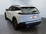 the rear view of a white suv parked in a showroom