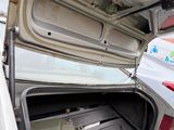 an open trunk of a car that is parked on the side of the road