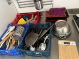 many kitchen utensils and cooking utensils on the kitchen counter