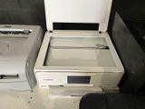 two printers sitting next to each other on a table