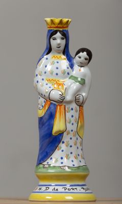 a statue of a woman holding a child on a table