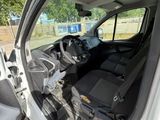 the interior of a white van with the door open