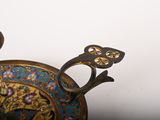a gold and blue plate with a bird on it